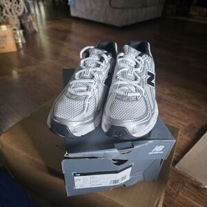 New Balance Silver and Black Sneakers